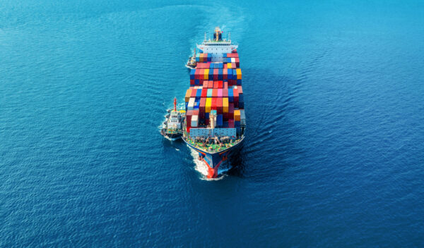 Aerial view of cargo ship with cargo container on sea.